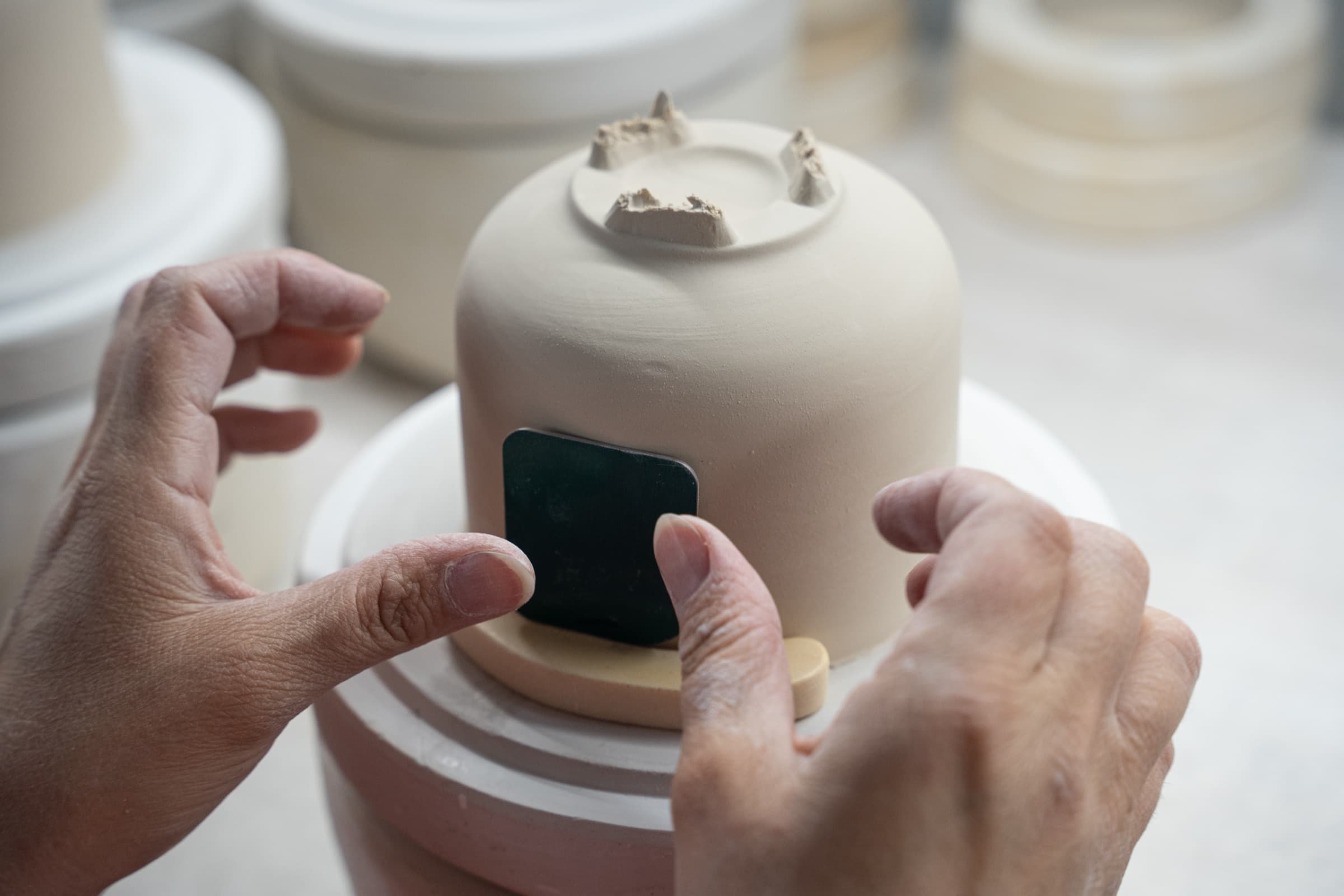 Hands shaping porcelain